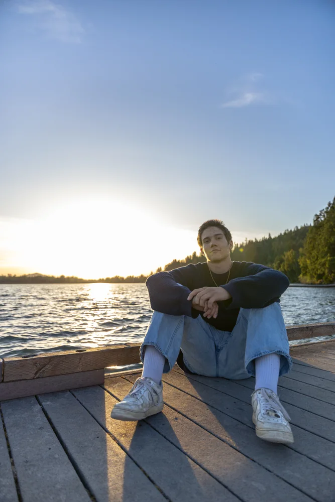 Seated portrait on a dock in golden evening light