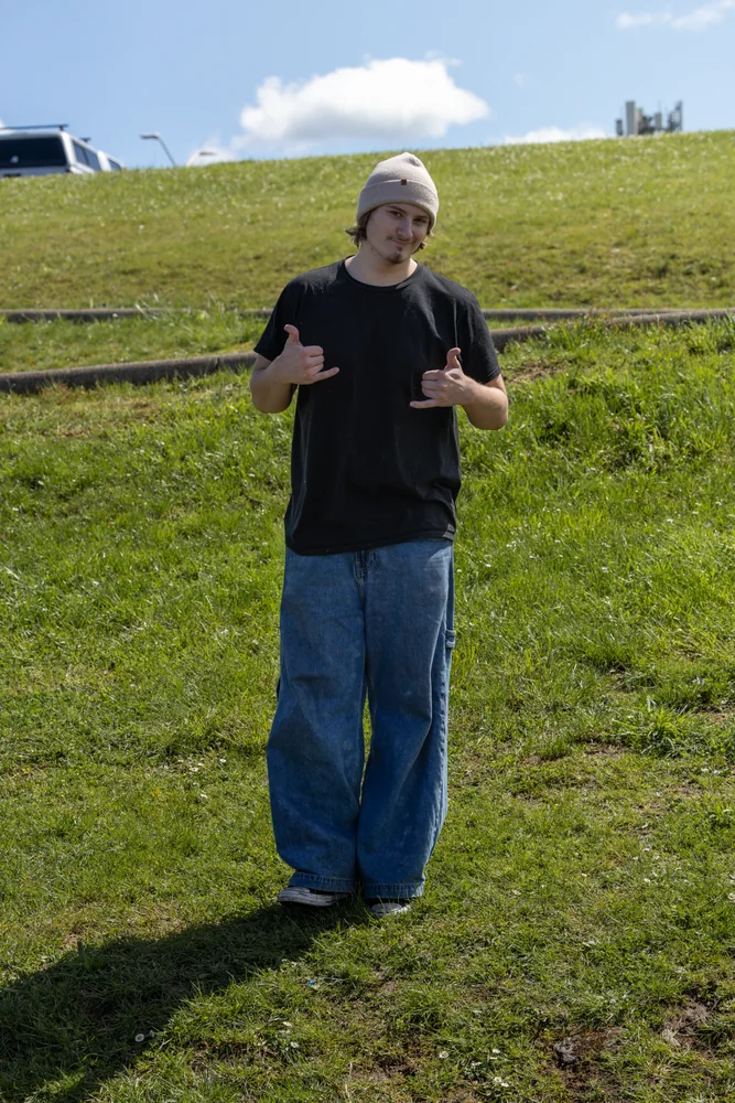 Full-length portrait on a green hillside