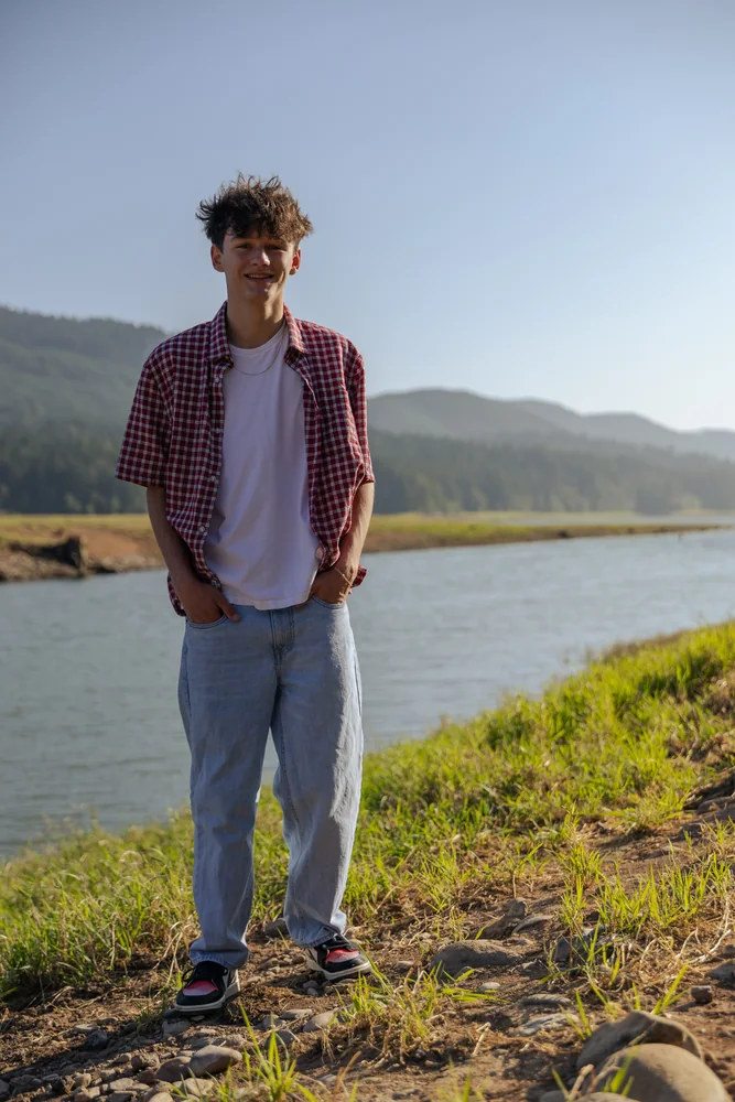 Portrait on a hillside above a mountain lake