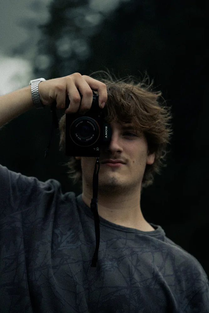 A person holding a camera up to their face
