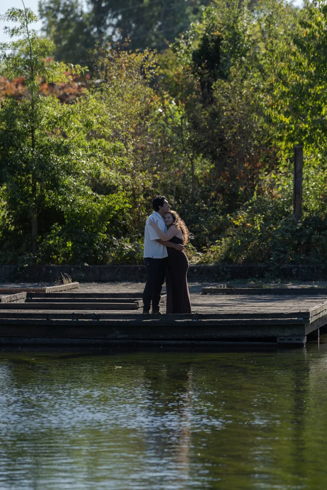 A couple sharing a quiet moment on a waterside dock