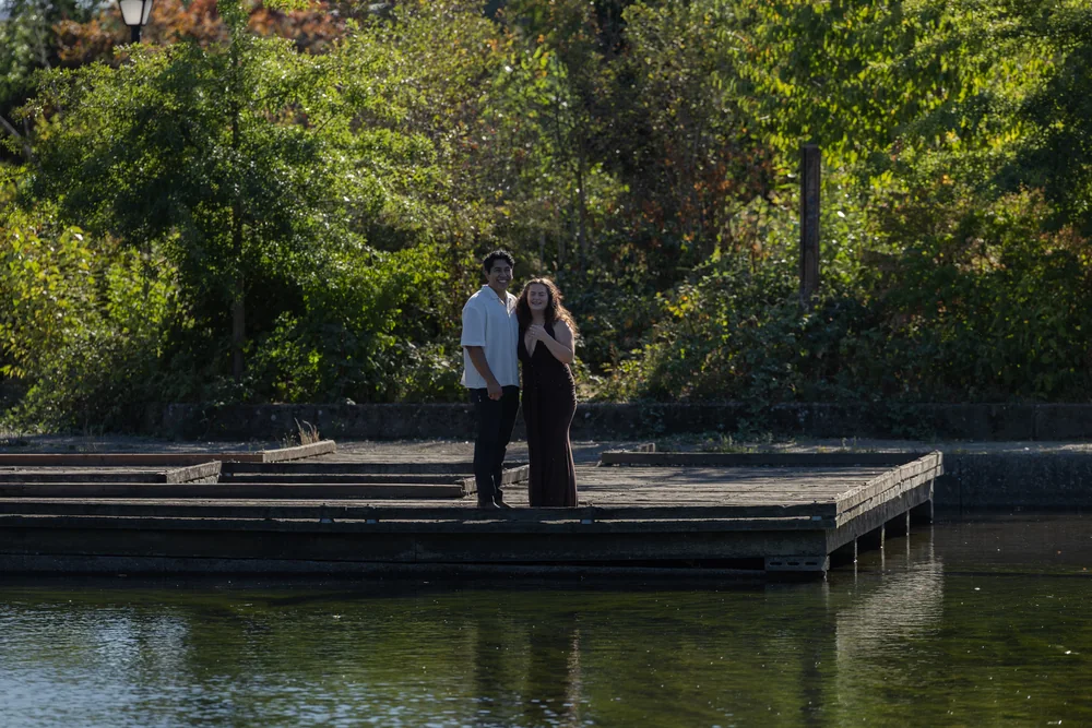 Wide view of the couple embracing on the dock