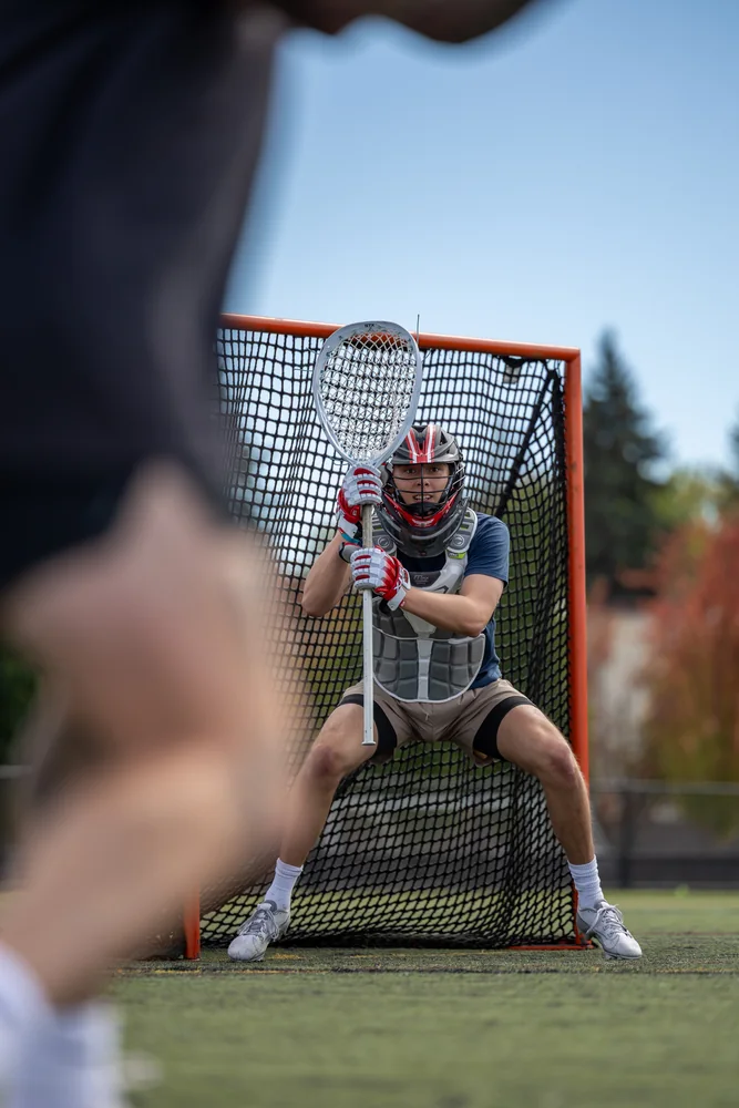 Lacrosse goalkeeper framed by another player