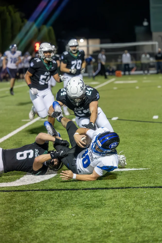 Football players colliding during a tackle