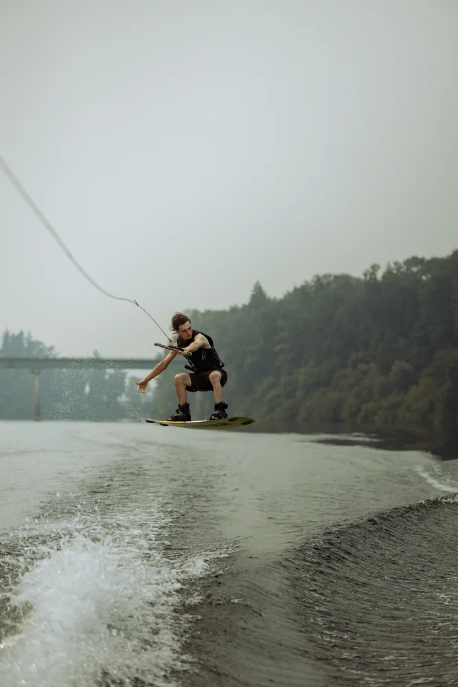 Wakeboarder riding across a lake