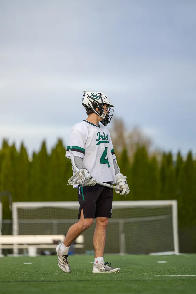 Lacrosse player running across the field