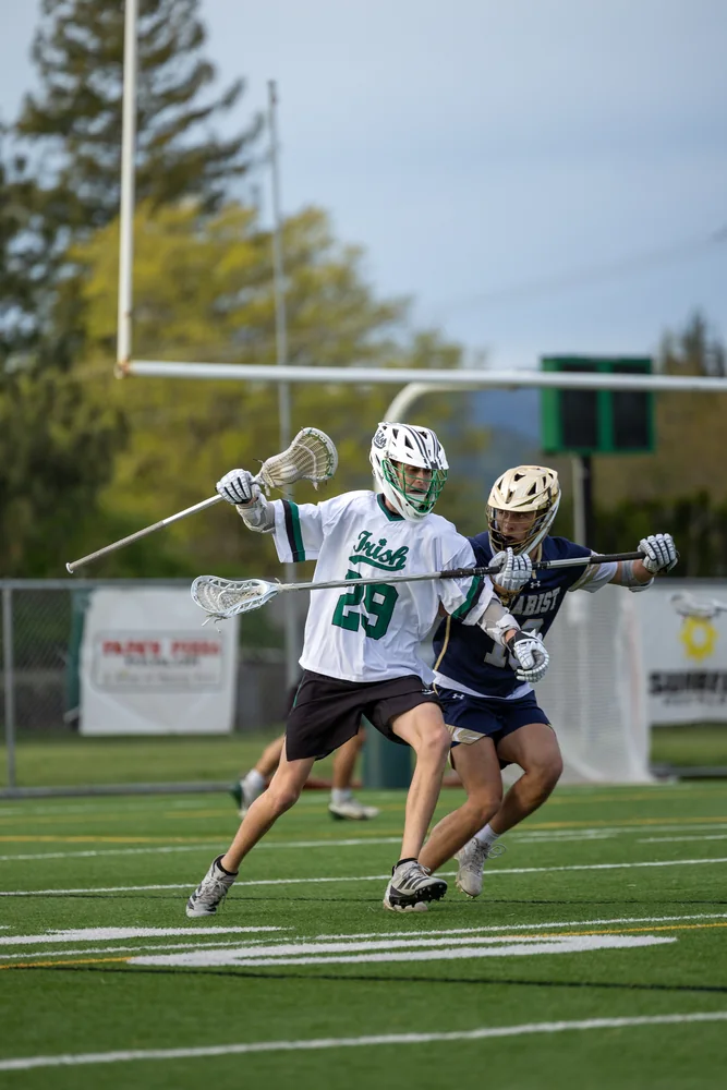 Two lacrosse players contesting possession