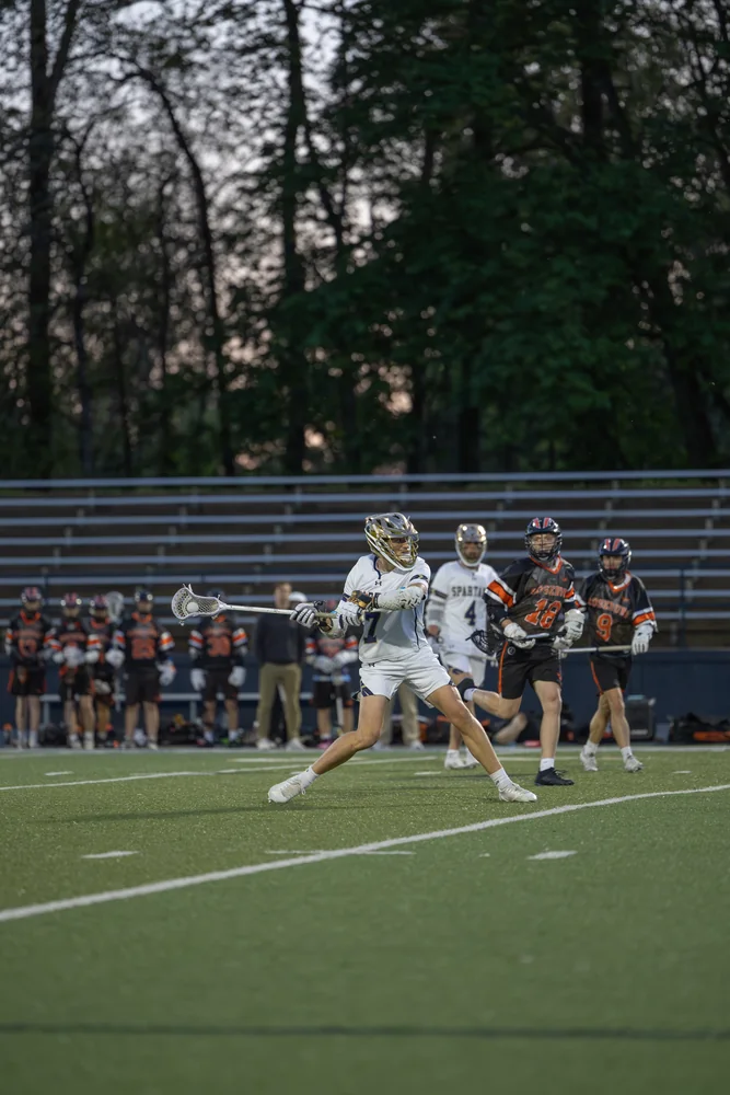 Lacrosse players converging during a game