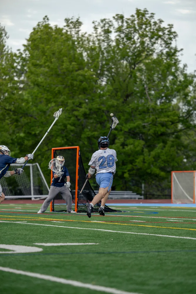 Lacrosse action in front of the goal
